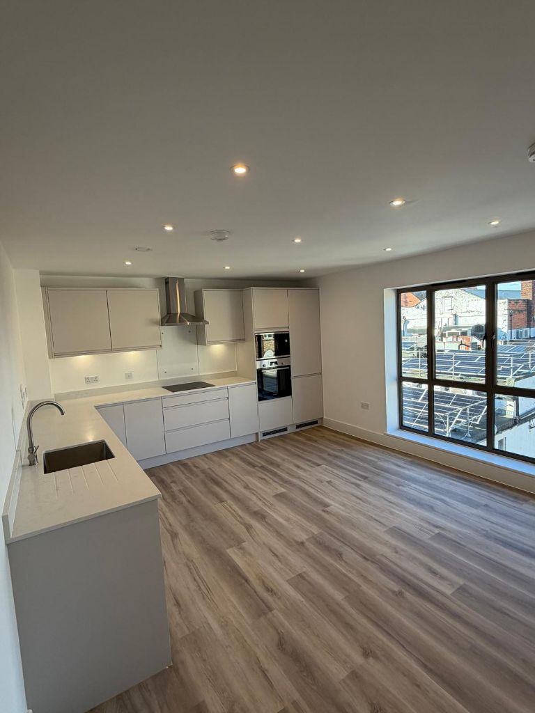 Modern open-plan kitchen and living room with professional electrical installation