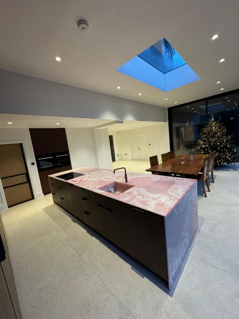 Stunning kitchen with pink quartz island and skylight electrical work
