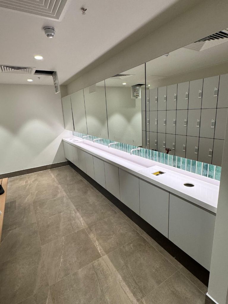 Commercial washroom electrical installation with long vanity unit
